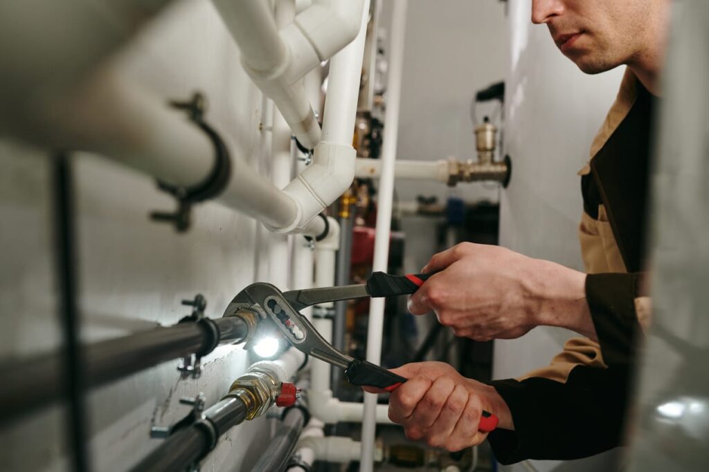 Plumbers maintaining commercial plumbing pipes in Seaside