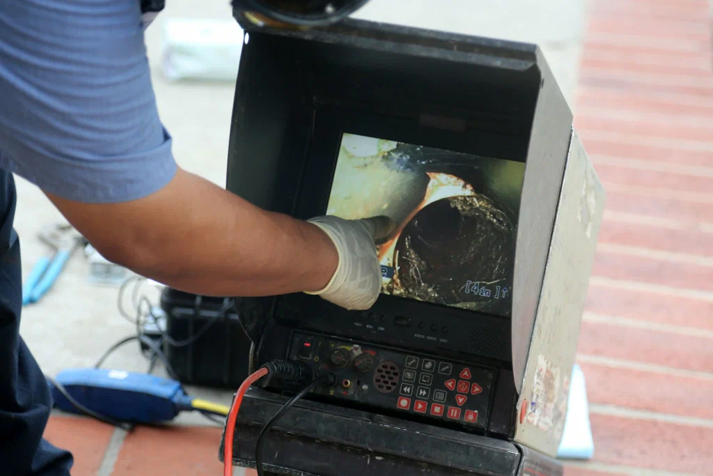 Technician viewing a drain inspection camera in Seaside